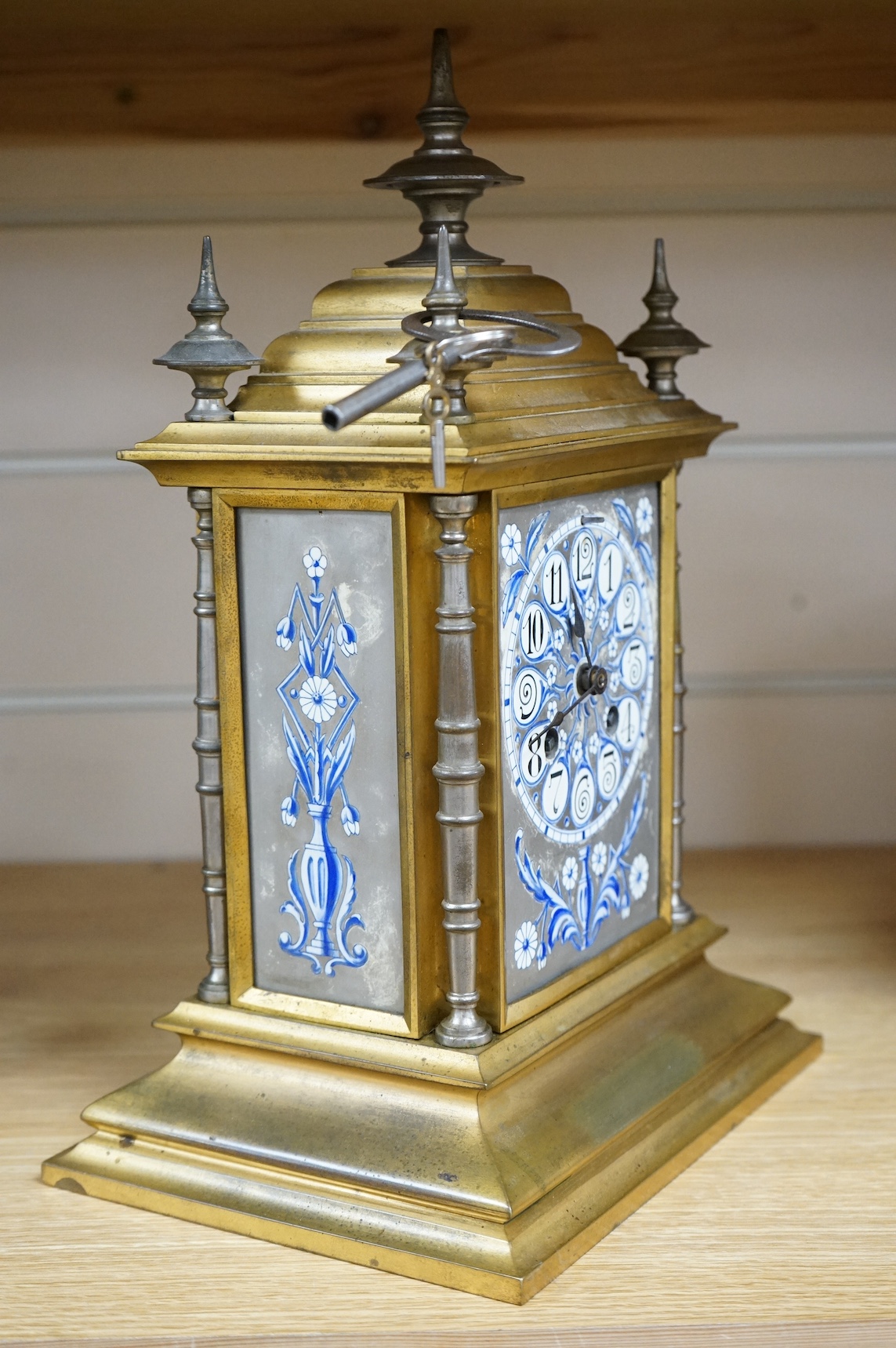 An Aesthetic style gilt brass and porcelain mounted mantel clock, striking on a bell, retailed by Frodsham, with key, 31cm high. Condition - fair/good, untested
